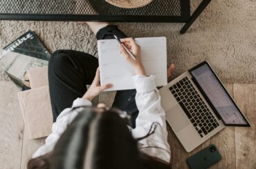 Open notebook and coffee mug on a journal , symbolizing writing after a break and gentle creative return.